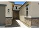 Inviting home entrance featuring a walkway, stylish brick accents, and neutral stucco at 5508 N 192Nd Ave, Litchfield Park, AZ 85340