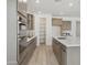 Modern kitchen featuring stainless steel appliances, an island, and a walk-in pantry at 5508 N 192Nd Ave, Litchfield Park, AZ 85340