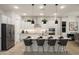 Bright, modern kitchen with stainless steel appliances, bar seating, and stylish pendant lighting at 5508 N 192Nd Ave, Litchfield Park, AZ 85340