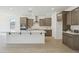 Modern kitchen features a large center island, stainless steel appliances, and wooden cabinetry at 5508 N 192Nd Ave, Litchfield Park, AZ 85340