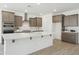 Beautiful open-concept kitchen with large island, stainless steel appliances, and ample counter space at 5508 N 192Nd Ave, Litchfield Park, AZ 85340