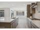 Bright, open kitchen with stainless steel appliances, island, and ample counter space at 5508 N 192Nd Ave, Litchfield Park, AZ 85340