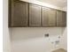 Spacious laundry room with overhead cabinets and utility hookups at 5508 N 192Nd Ave, Litchfield Park, AZ 85340