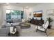 Bright living room featuring stylish decor and sliding glass doors to the patio at 5508 N 192Nd Ave, Litchfield Park, AZ 85340