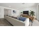 Spacious living room featuring modern decor, large sectional sofa, and a television at 5508 N 192Nd Ave, Litchfield Park, AZ 85340