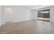 Bright living area with access to backyard and featuring wood-look tile flooring at 5508 N 192Nd Ave, Litchfield Park, AZ 85340
