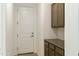 Neutral-toned mud room featuring a white door, cabinets, and light walls at 5508 N 192Nd Ave, Litchfield Park, AZ 85340