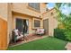 Back patio with artificial grass, brick tile, seating, and a sliding glass door at 5704 E Aire Libre Ave # 1044, Scottsdale, AZ 85254