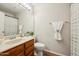 Well-lit bathroom features tile floors, warm wood vanity, and neutral colored walls at 5704 E Aire Libre Ave # 1044, Scottsdale, AZ 85254