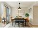 Dining area with modern lighting fixture, neutral decor, and sliding glass door to the patio at 5704 E Aire Libre Ave # 1044, Scottsdale, AZ 85254