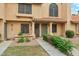 Charming tan townhome with tile roof, decorative pillars, manicured landscaping, and address numbers at 5704 E Aire Libre Ave # 1044, Scottsdale, AZ 85254