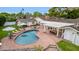 Aerial view of a home with a kidney-shaped pool, lush landscaping, and a covered patio area at 5801 E Exeter Blvd, Phoenix, AZ 85018