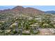 Expansive aerial view of a residential neighborhood with mature landscaping and mountain views at 5801 E Exeter Blvd, Phoenix, AZ 85018