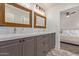 Bathroom featuring a double sink vanity with marble countertop and a view into a bedroom at 5801 E Exeter Blvd, Phoenix, AZ 85018