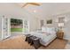 Serene bedroom features french doors to the back yard, a neutral color palette, and vaulted ceilings at 5801 E Exeter Blvd, Phoenix, AZ 85018