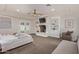 Serene main bedroom featuring a fireplace, built-in shelving, and access to a private outdoor space at 5801 E Exeter Blvd, Phoenix, AZ 85018