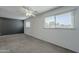 An empty bedroom with neutral carpeting, a ceiling fan and lots of natural light at 5853 E Thomas Rd, Scottsdale, AZ 85251