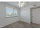 Bedroom with neutral carpeting, ceiling fan and a built in closet at 5853 E Thomas Rd, Scottsdale, AZ 85251