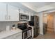 Well-lit kitchen features stainless steel appliances, white cabinetry, and subway tile backsplash at 5853 E Thomas Rd, Scottsdale, AZ 85251