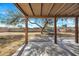 Covered backyard patio with view of spacious backyard and large shade tree at 635 W Pecos Ave, Mesa, AZ 85210