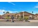 Charming single-story home featuring desert landscaping, covered front porch, and a spacious driveway under a clear blue sky at 635 W Pecos Ave, Mesa, AZ 85210