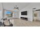 Bright living room featuring tile flooring, a ceiling fan, and a large window providing ample natural light at 635 W Pecos Ave, Mesa, AZ 85210