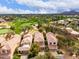 Aerial view showcasing an idyllic golf course community with lush green landscapes and tiled-roof homes at 7525 E Gainey Ranch Rd # 110, Scottsdale, AZ 85258