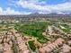 Gorgeous aerial view of homes nestled around a green golf course set against a mountain backdrop at 7525 E Gainey Ranch Rd # 110, Scottsdale, AZ 85258