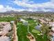 Scenic aerial view of golf course with ponds and lush greens surrounded by beautiful homes at 7525 E Gainey Ranch Rd # 110, Scottsdale, AZ 85258