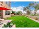 Landscaped backyard with lush lawn, patio, and desert landscaping, offering a serene outdoor space at 7525 E Gainey Ranch Rd # 110, Scottsdale, AZ 85258