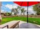 Lush backyard featuring a well-manicured lawn, lounge chair, and mature trees at 7525 E Gainey Ranch Rd # 110, Scottsdale, AZ 85258