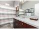 Well-lit bathroom with a modern vanity, framed mirror, and a shower-tub combination at 7525 E Gainey Ranch Rd # 110, Scottsdale, AZ 85258