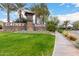 Beautifully landscaped entrance to Gainey Ranch with stone signage, mature palm trees, and lush green lawns at 7525 E Gainey Ranch Rd # 110, Scottsdale, AZ 85258