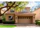 Inviting two-story home featuring a tile roof, well-manicured landscaping, and a spacious two-car garage at 7525 E Gainey Ranch Rd # 110, Scottsdale, AZ 85258