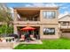 Exterior of home featuring a patio, balcony, lush lawn and desert landscaping at 7525 E Gainey Ranch Rd # 110, Scottsdale, AZ 85258