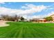 Expansive view of a beautifully manicured golf course with residential homes, showcasing desert landscaping and mature trees at 7525 E Gainey Ranch Rd # 110, Scottsdale, AZ 85258