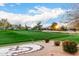 Scenic view of a golf course with desert landscaping and vibrant greenery, set against a bright blue sky at 7525 E Gainey Ranch Rd # 110, Scottsdale, AZ 85258