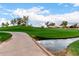 Picturesque golf course featuring a paved path over water, surrounded by lush green grass and mature trees at 7525 E Gainey Ranch Rd # 110, Scottsdale, AZ 85258