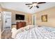 Bedroom features ceiling fan, dark wood floors and a large window at 8431 W Planada Ln, Peoria, AZ 85383