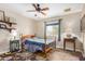 Bedroom with ceiling fan, wood floor, and window with view at 8431 W Planada Ln, Peoria, AZ 85383