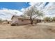 Back side view of a ranch-style home with neutral paint and minimal desert landscaping at 8431 W Planada Ln, Peoria, AZ 85383