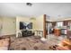 Open concept living room with dark wood floors, a TV, and access to the kitchen at 8431 W Planada Ln, Peoria, AZ 85383