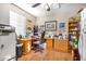 Cozy home office with wood floors, built-in desk, ample storage and natural light from a window at 8431 W Planada Ln, Peoria, AZ 85383