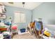 Functional spare room featuring light blue walls and wood-look tile at 8431 W Planada Ln, Peoria, AZ 85383