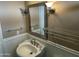 Cozy bathroom featuring a pedestal sink, classic lighting, and wood-paneled walls for a timeless look at 8601 E Berridge Ln, Scottsdale, AZ 85250