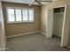 Cozy bedroom features natural light, a ceiling fan, and carpet floors at 8601 E Berridge Ln, Scottsdale, AZ 85250