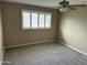 This spacious bedroom features neutral walls, new carpet and window with white shutters and a ceiling fan at 8601 E Berridge Ln, Scottsdale, AZ 85250