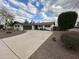 Well-maintained single-story home with a spacious driveway and desert landscaping at 8601 E Berridge Ln, Scottsdale, AZ 85250