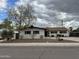 Quaint single-story home with neat landscaping and a mature shade tree in front at 8601 E Berridge Ln, Scottsdale, AZ 85250