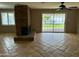 Cozy living room with brick fireplace, view to the backyard and a large window at 8601 E Berridge Ln, Scottsdale, AZ 85250